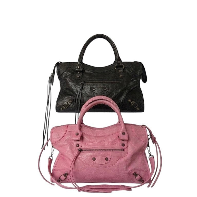 Black / pink vegan leather city bag with braided handles and studded details.