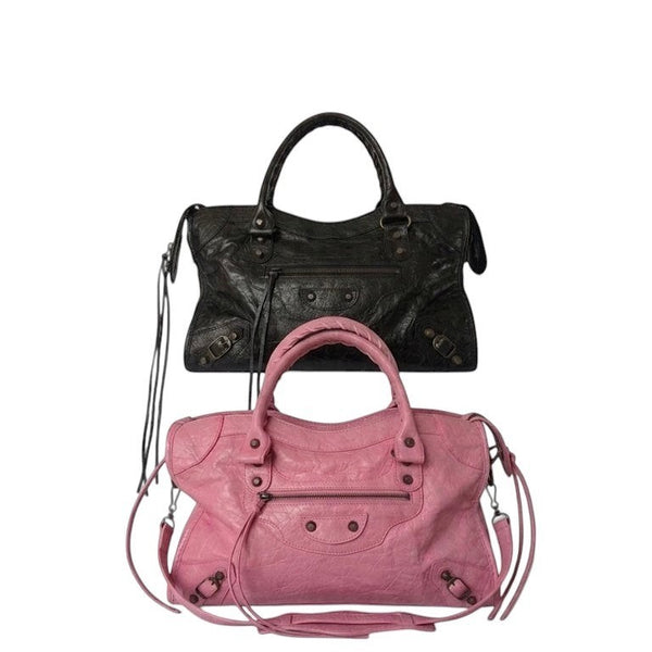 Black / pink vegan leather city bag with braided handles and studded details.